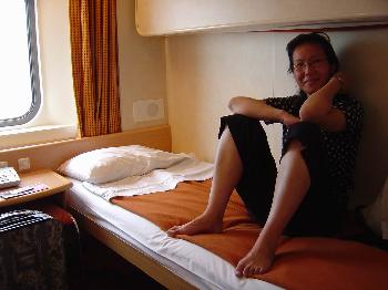 July 1, 2005, Lei on the bed in our sleeper berth on the ferry from Ancona, Italy to Patras, Greece
